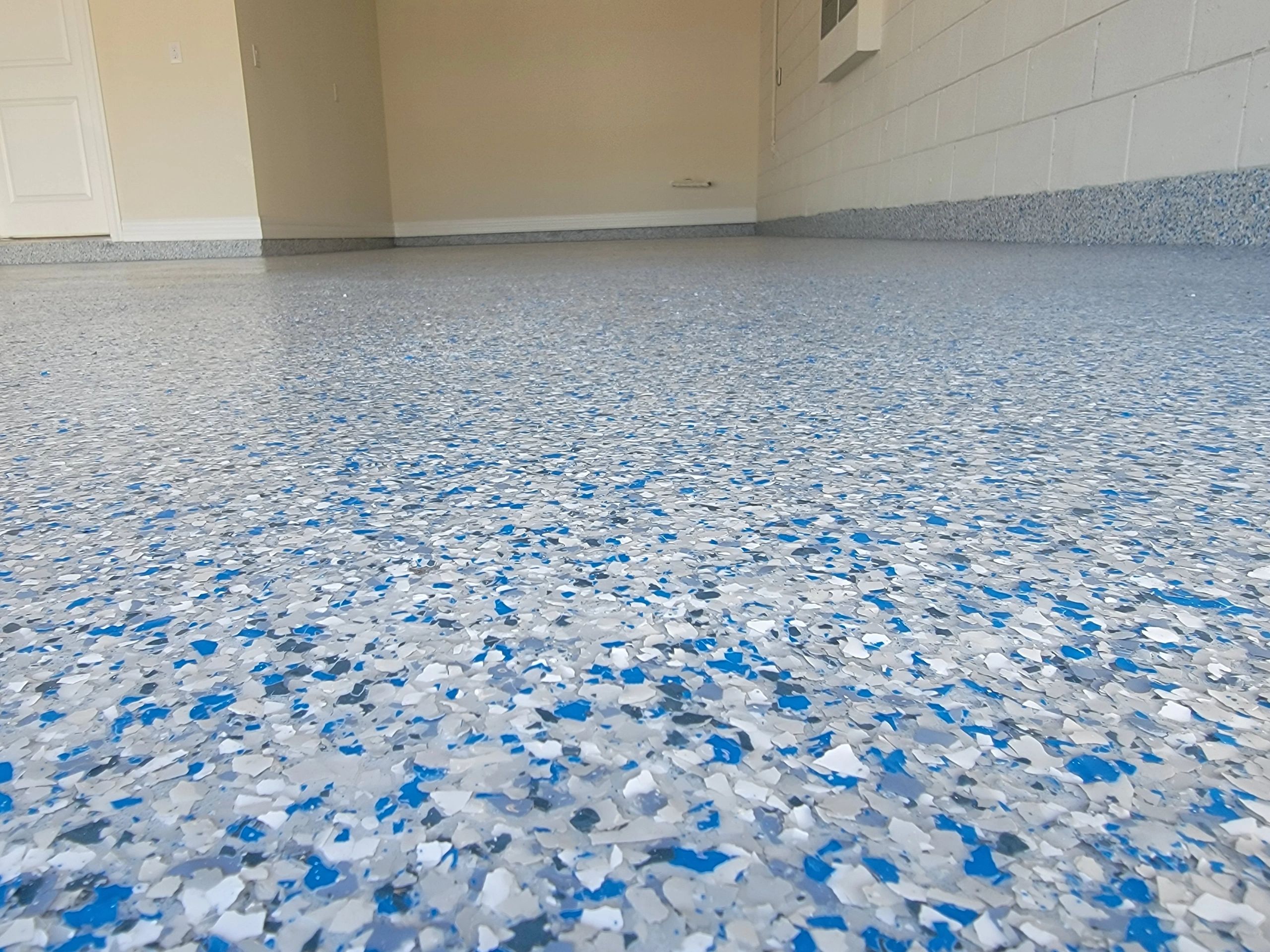 Blue speckled epoxy floor in commercial space